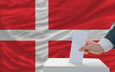 Image showing man voting on elections in denmark in front of flag