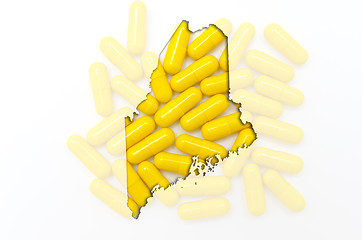 Image showing Outline map of maine with transparent pills in the background