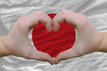 Image showing Heart and love gesture showed by hands over flag of japan backgr