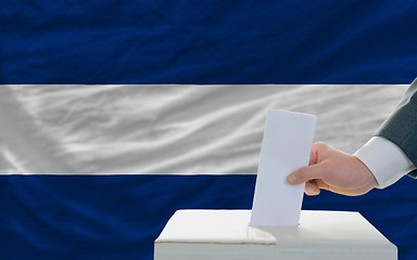 Image showing man voting on elections in nicaragua in front of flag