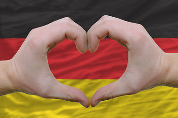 Image showing Heart and love gesture showed by hands over flag of germany back