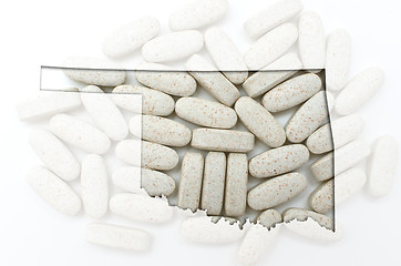 Image showing Outline map of oklahoma with transparent pills in the background