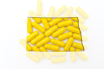 Image showing Outline map of north dakota with transparent pills in the backgr