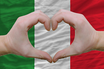 Image showing Heart and love gesture showed by hands over flag of italy backgr