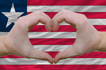 Image showing Heart and love gesture showed by hands over flag of liberia back