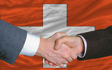 Image showing businessmen handshake after good deal in front of swiss flag