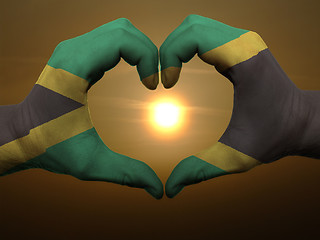 Image showing Heart and love gesture by hands colored in jamaica flag during b