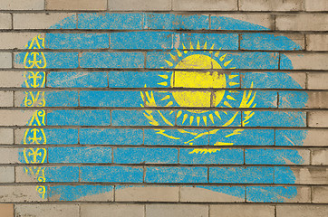 Image showing flag of Khazakstan on grunge brick wall painted with chalk  