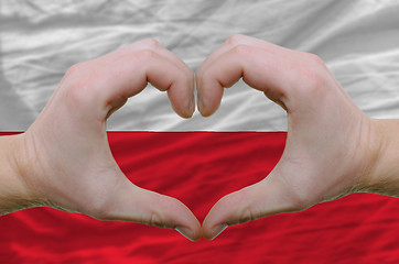 Image showing Heart and love gesture showed by hands over flag of poland backg