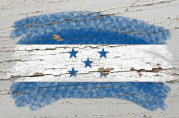 Image showing flag of Honduras on grunge wooden texture painted with chalk  