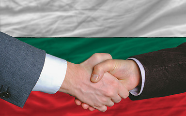 Image showing businessmen handshake after good deal in front of bulgaria flag