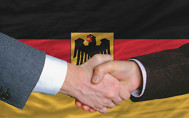 Image showing businessmen handshake after good deal in front of germany flag