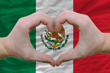 Image showing Heart and love gesture showed by hands over flag of mexico backg