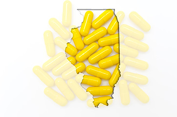 Image showing Outline map of Illionis with transparent pills in the background