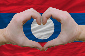 Image showing Heart and love gesture showed by hands over flag of laos backgro