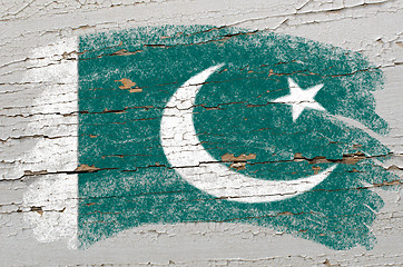 Image showing flag of Pakistan on grunge wooden texture painted with chalk  