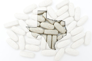 Image showing Outline map of texas with transparent pills in the background