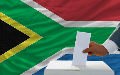 Image showing man voting on elections in south africa in front of flag