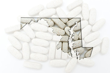 Image showing Outline map of maryland with transparent pills in the background