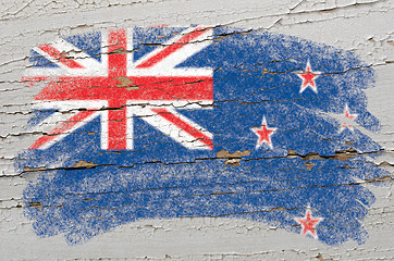 Image showing flag of New Zealand on grunge wooden texture painted with chalk 
