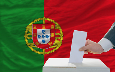 Image showing man voting on elections in portugal in front of flag