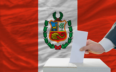 Image showing man voting on elections in peru in front of flag