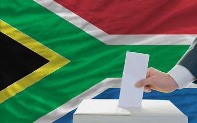 Image showing man voting on elections in south africa in front of flag