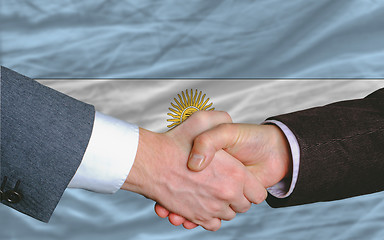 Image showing businessmen handshake after good deal in front of argentina flag