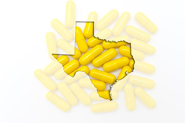 Image showing Outline map of texas with transparent pills in the background