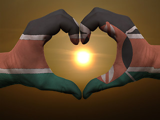 Image showing Heart and love gesture by hands colored in kenya flag during bea