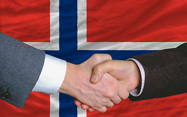 Image showing businessmen handshake after good deal in front of norway flag
