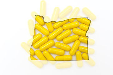 Image showing Outline map of oregon with transparent pills in the background