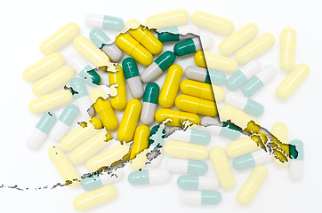 Image showing Outline Alaska map of with transparent pills in the background