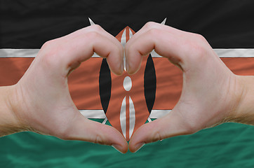 Image showing Heart and love gesture showed by hands over flag of kenya backgr