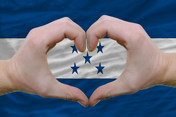 Image showing Heart and love gesture showed by hands over flag of honduras bac