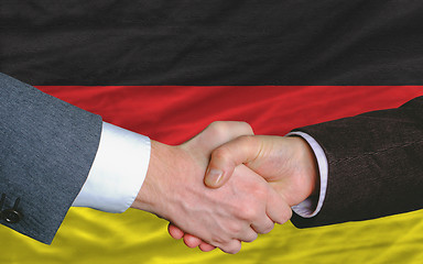 Image showing businessmen handshake after good deal in front of germany flag