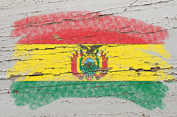 Image showing flag of bolivia on grunge wooden texture painted with chalk  