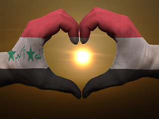 Image showing Heart and love gesture by hands colored in iraq flag during beau