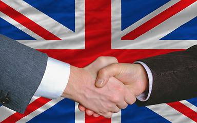 Image showing businessmen handshake after good deal in front of uk flag