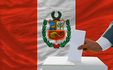 Image showing man voting on elections in peru in front of flag