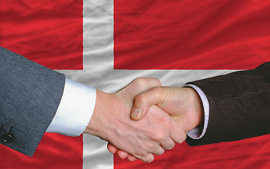 Image showing businessmen handshake after good deal in front of denmark flag