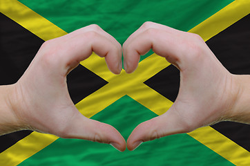 Image showing Heart and love gesture showed by hands over flag of jamaica back