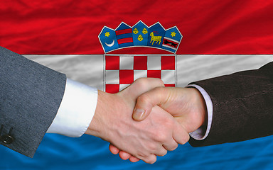 Image showing businessmen handshakeafter good deal in front of croatia flag