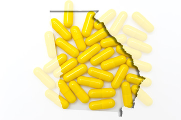 Image showing Outline map of Georgia with transparent pills in the background