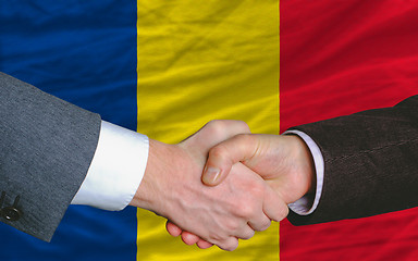 Image showing businessmen handshake after good deal in front of romania flag