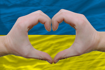 Image showing Heart and love gesture showed by hands over flag of ukraine back