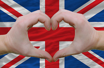 Image showing Heart and love gesture showed by hands over flag of uk backgroun