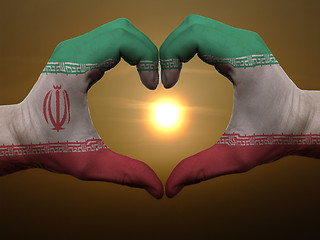 Image showing Heart and love gesture by hands colored in iran flag during beau