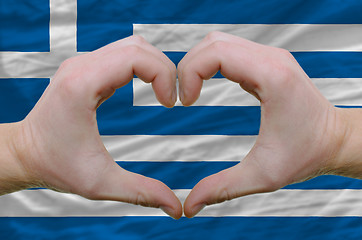 Image showing Heart and love gesture showed by hands over flag of greece backg