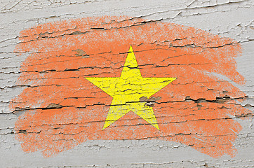 Image showing flag of vietnam on grunge wooden texture painted with chalk  